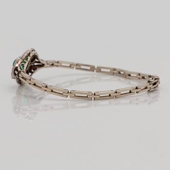 A cabochon cut emerald and brilliant cut diamond bracelet. Total carat weight of diamonds circa 1.10 cts.