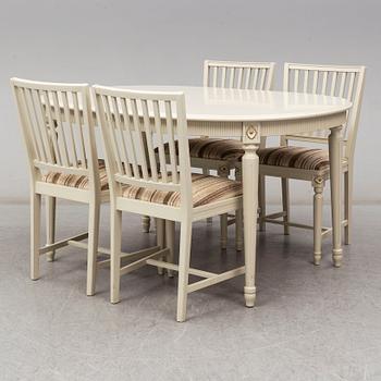 A dining table and 4 chairs, second half of the 20th century. 2 leaves included.