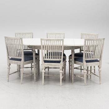 A Gustavian style dining table and six chairs, late 20th Century.