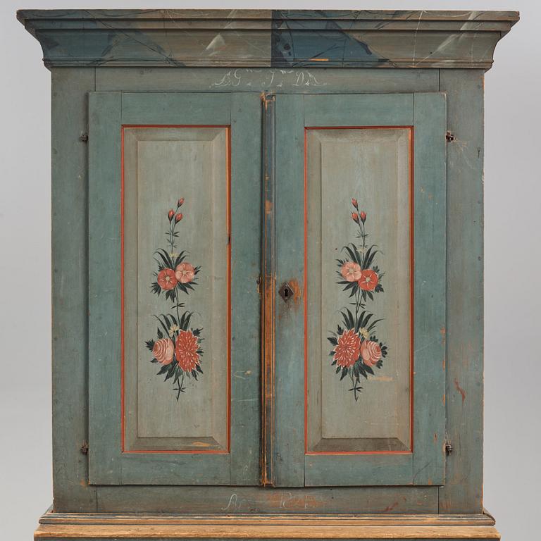 A polychrome-painted cabinet from Jämtland, Sweden, dated 1824.