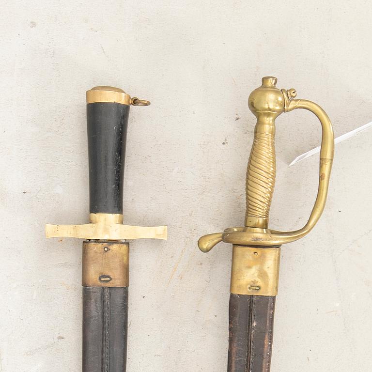 Two Swedish cutlasses 1856 pattern withs scabbards.