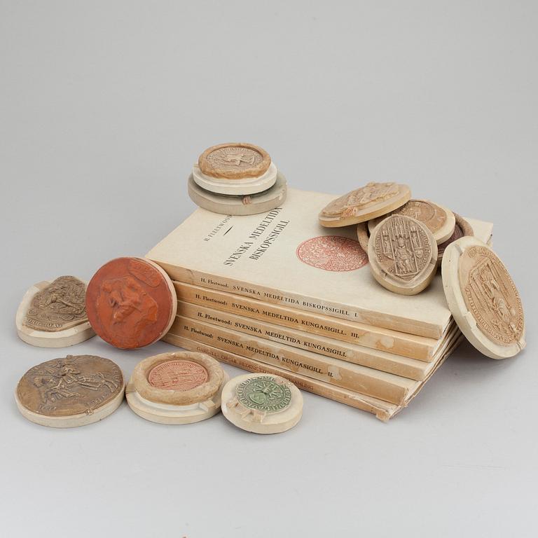 A collection of 12 plaster casts of medieval seals cast by Georg Fleetwood 1930/40s.