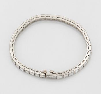 A platinum bracelet set with carré cut diamonds.