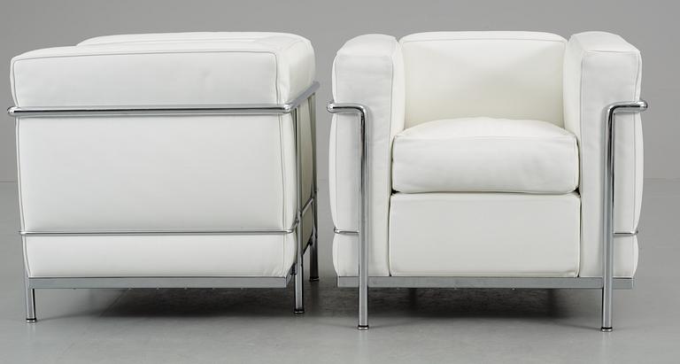 A pair of Le Corbusier, 'LC2' chromed steel and white leather easy chair, Cassina, Italy.