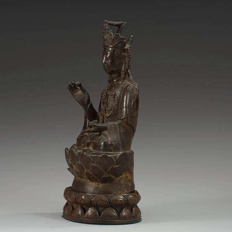 A bronze figure of Guanyin, Ming dynasty with archaistic lettering to back.