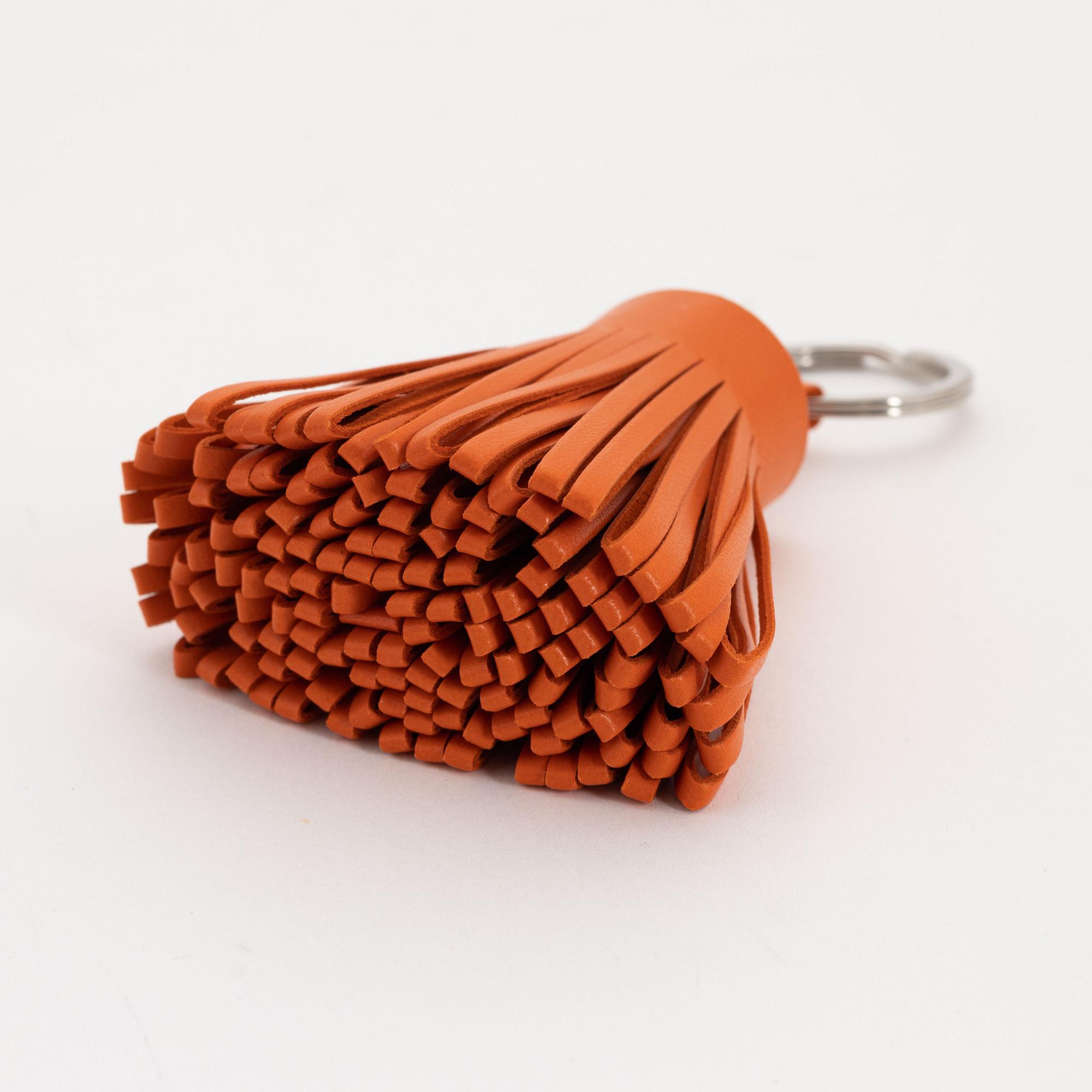 Hermès, a leather bracelet and key chain.