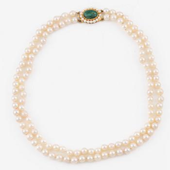 A two strand cultured pearl necklace, clasp in 18K gold with a green stone, likely malachite, and cultured pearls.