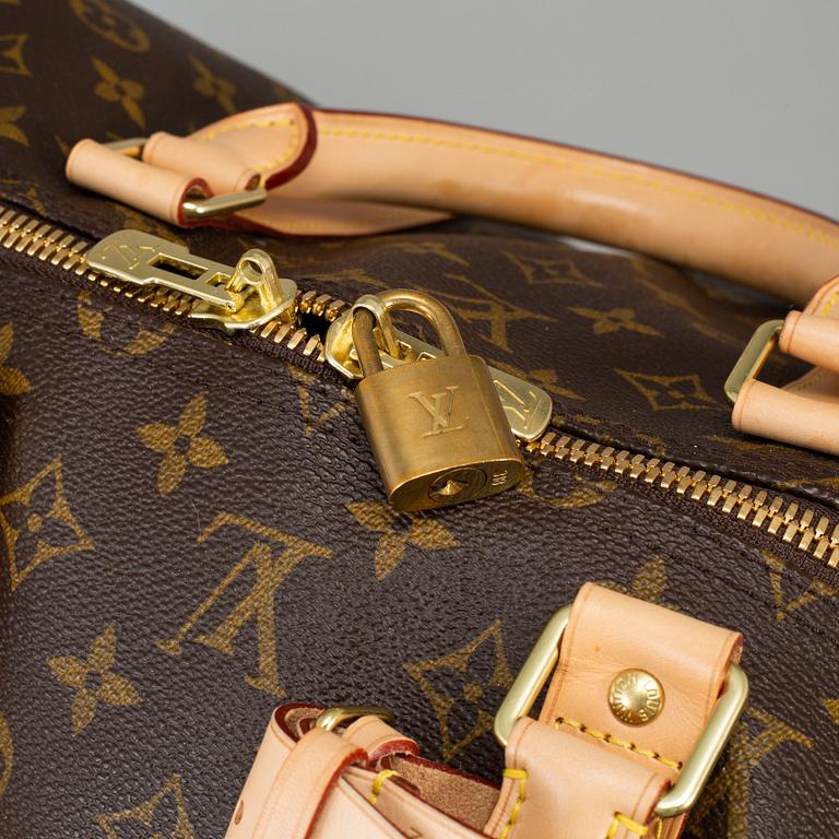 LOUIS VUITTON, a monogram canvas 'Keepall Bandoulière 55' weekend bag, 2014.