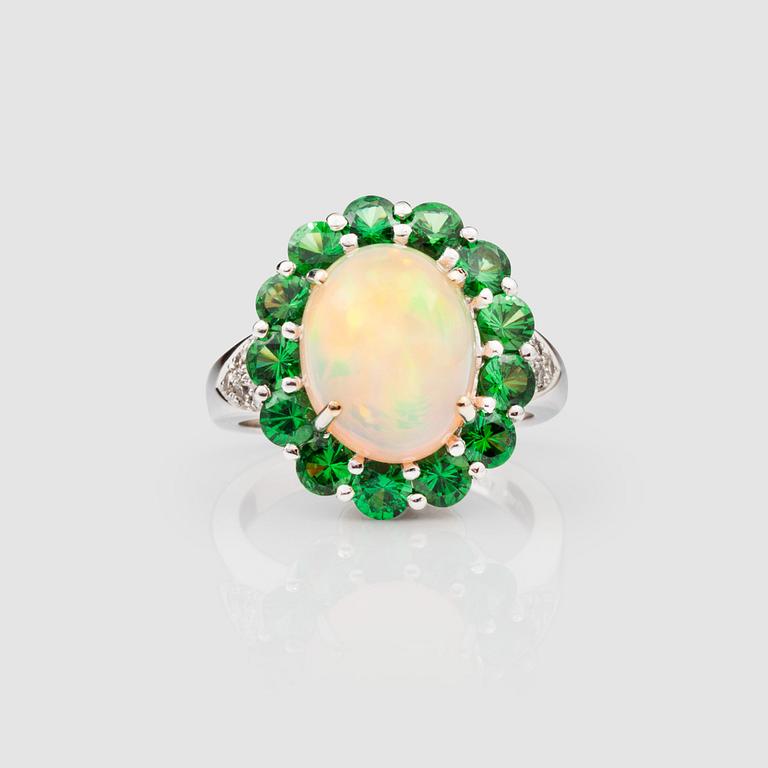 An Ethiopian opal, diamond and tsavorite ring.