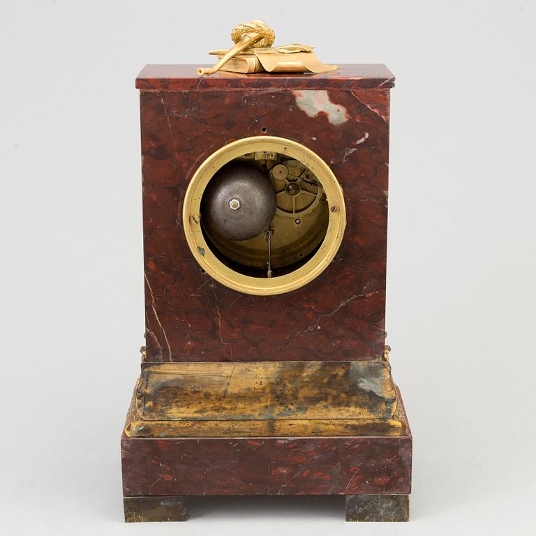 AN EMPIRE ORMOLU AND MARBLE MANTEL CLOCK, first half of the 19th century.