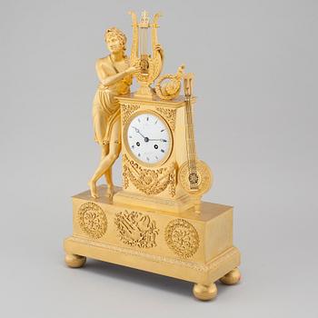 An Empire table clock, dial marked "L Ravrio Bronzier à Paris Mesnil H", fist half of the 20th century.