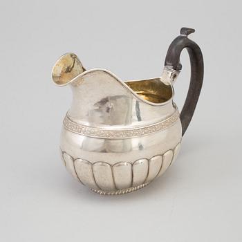 A Russian Empire parcel-gilt cream jug, maker's mark Elias Modig (1795-1834), St Petersburg, 1824.