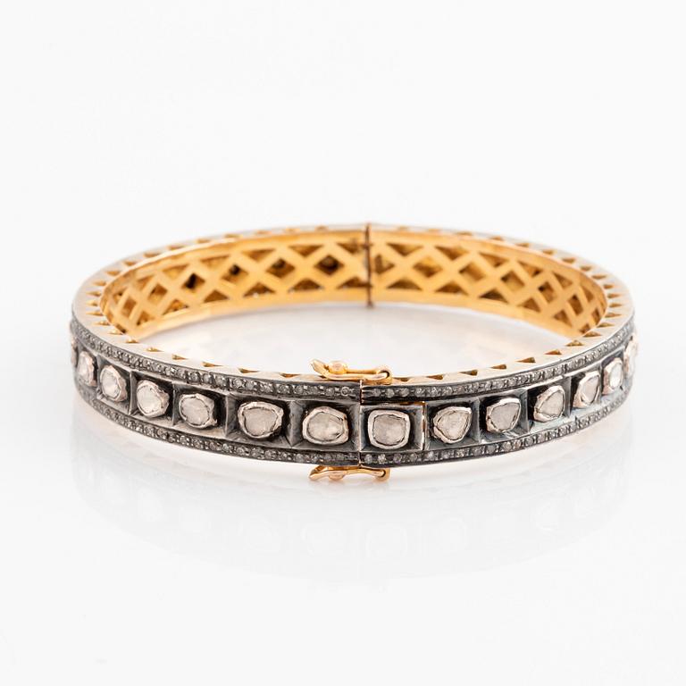 A faceted diamond bangle.