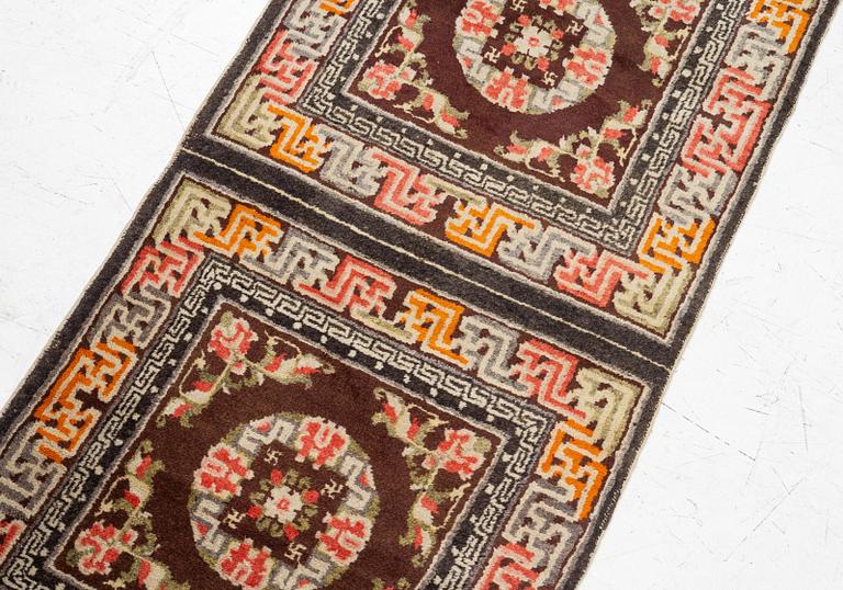 A Chinese two square rug, antique, c. 142 x 71 cm.