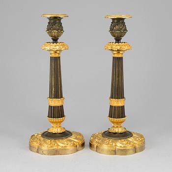 A pair of ormolu late empire candlesticks, mid 19th century.