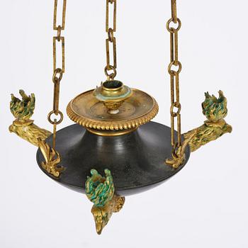 An Empire ormolu and patinated bronze four-light chandelier, Stockholm, early 19th century.