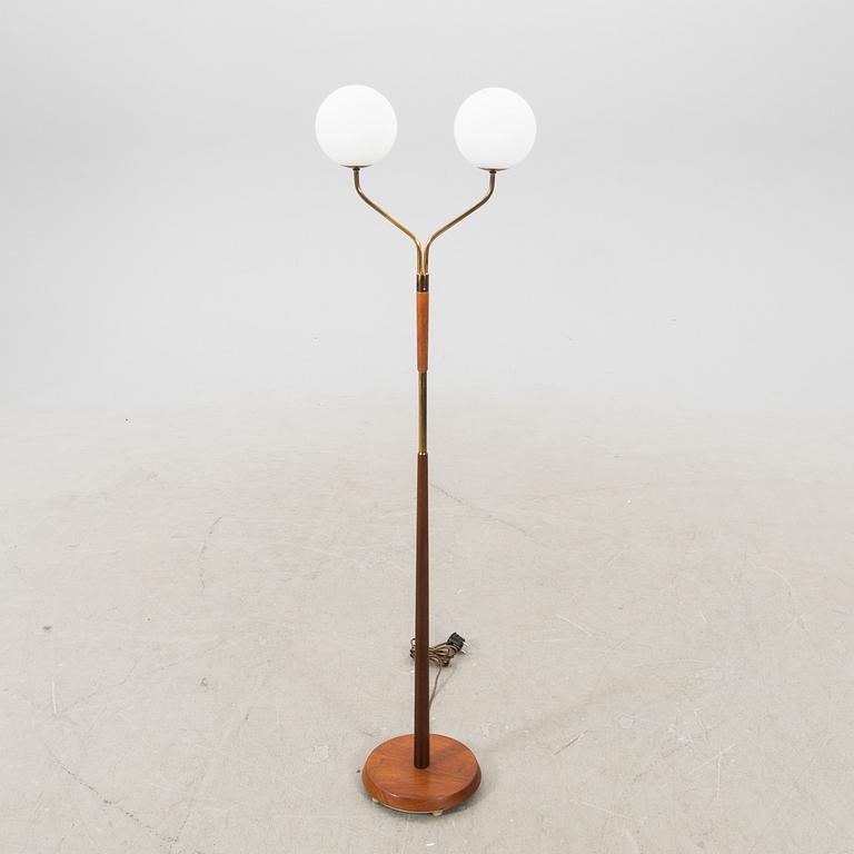 A mid 20th century teak and brass floor lamp.