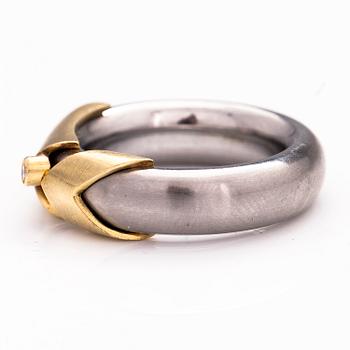 A steel and gold ring with a diamond ca. 0.015 ct.