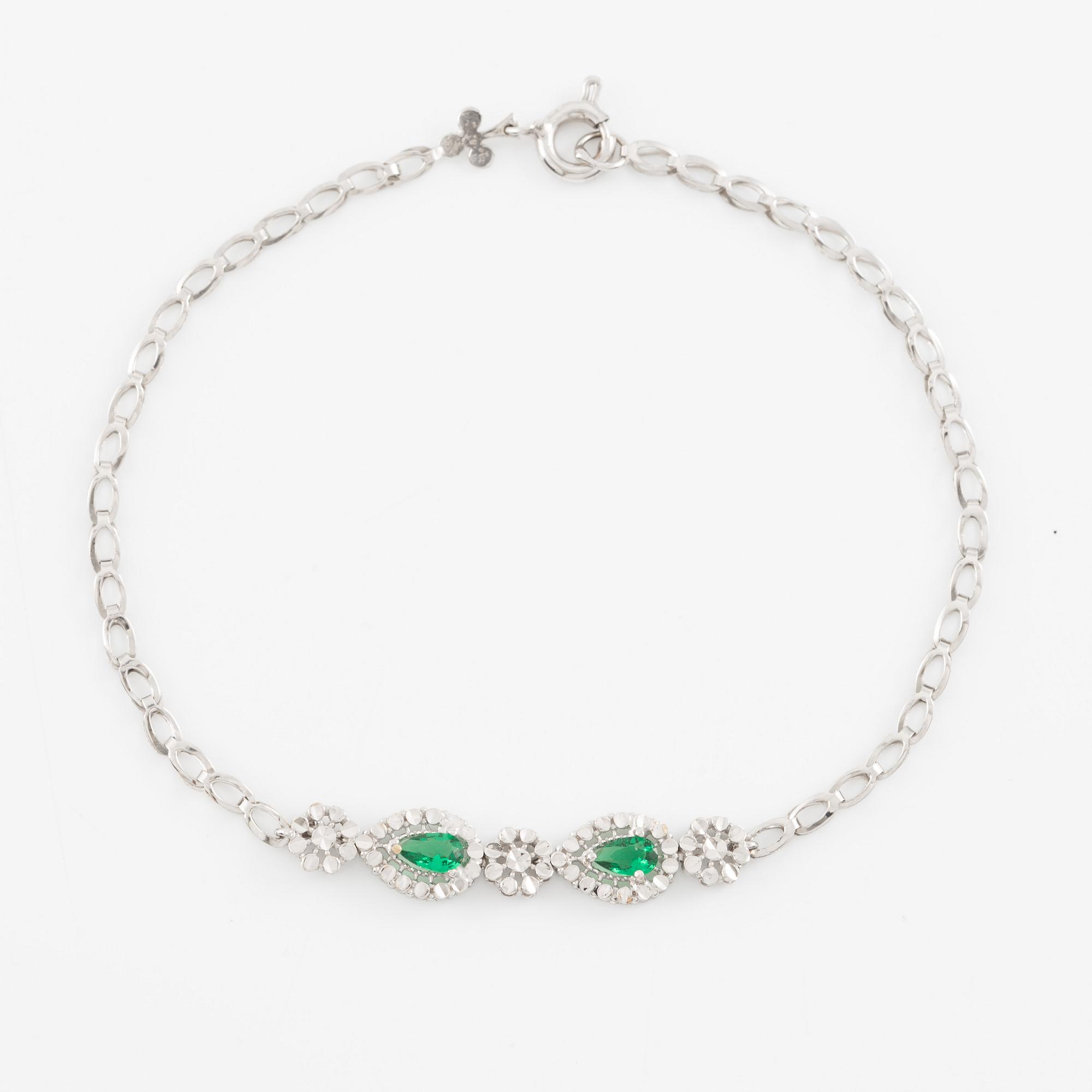 Armband 18K guld med gröna stenar.