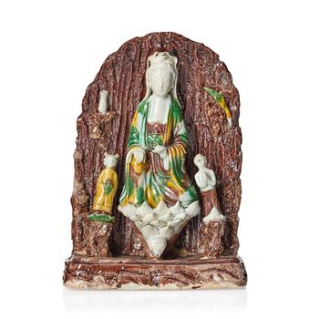 1045. A bisquit figure of Guanyin with two attendants in a grotto, Qing dynasty, Kangxi (1662-1722).