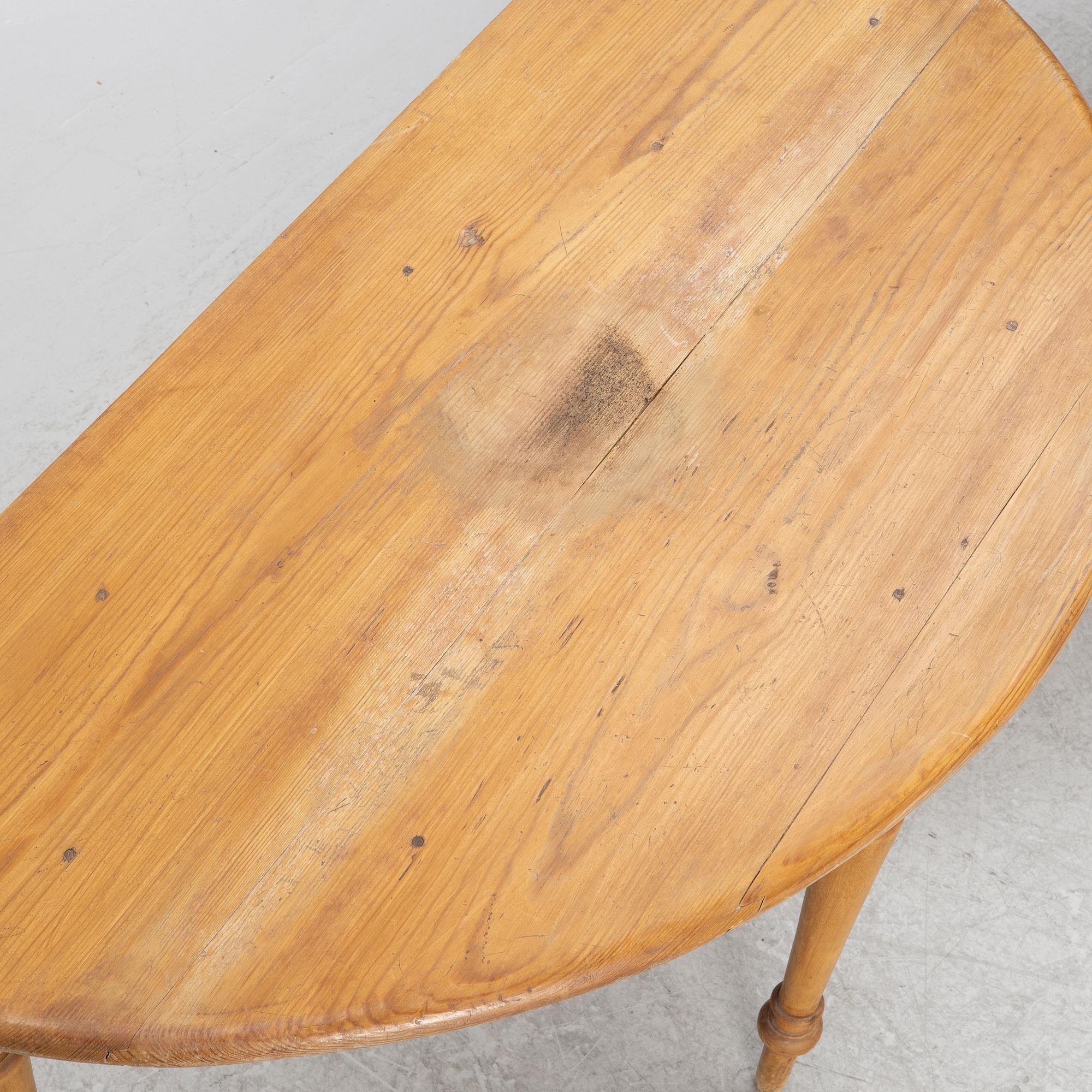 A round pine dining table/a pair of crescent shaped tables, Sweden, 19th century.