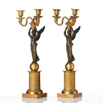 A pair of gilt and patinated bronze Empire-style two branch candelabra, later part 18th century.
