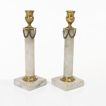 A pair of Gustavian brass and marble candlesticks, circa 1800.