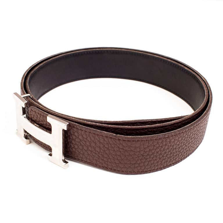 Brown togo belt "Constance" by Hermès.