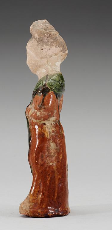 A green and yellow glazed figure of a standing lady, Tang dynasty.