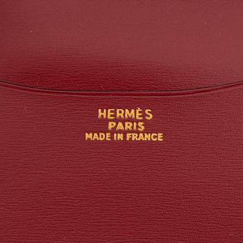 Hermès, a black leather notebook case & sterling silver pen.