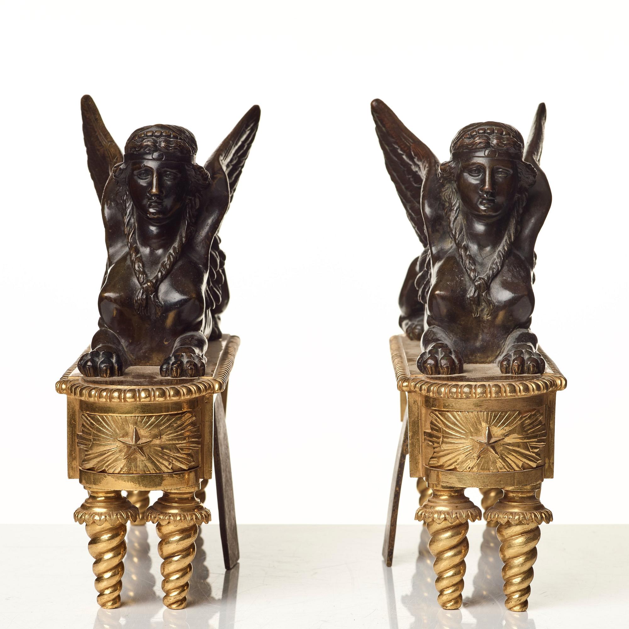 A pair of French Empire first half 19th century gilt and patinated bronze chenets.