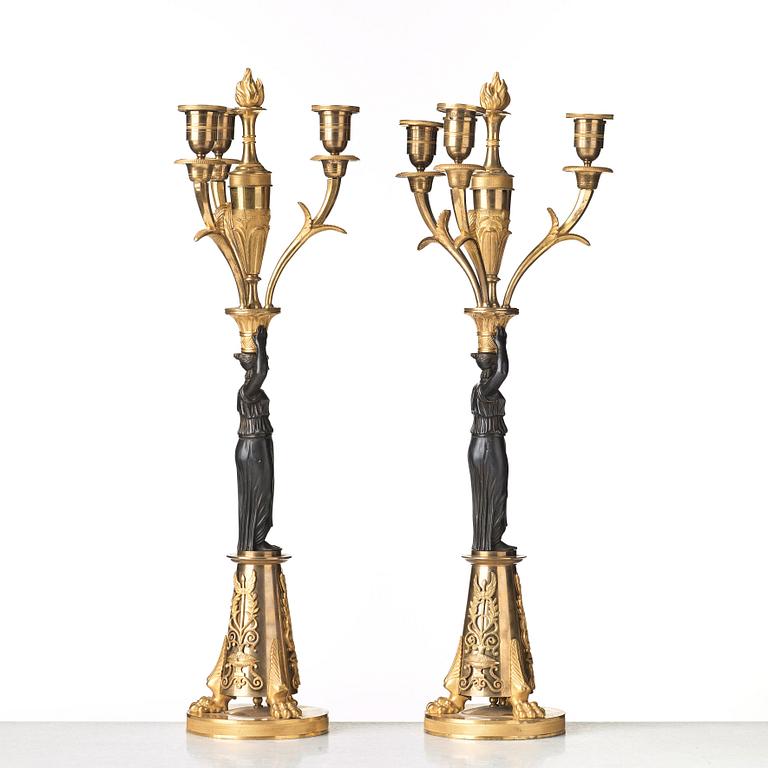 A pair of French Empire early 19th century three-light candelabra.