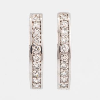 Brilliant-cut diamond hoop earrings.