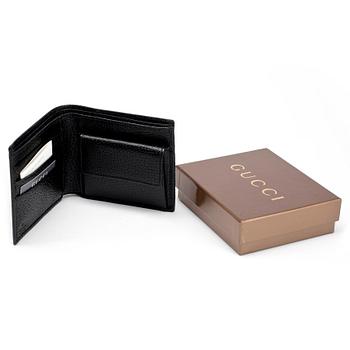 GUCCI, a black leather wallet.