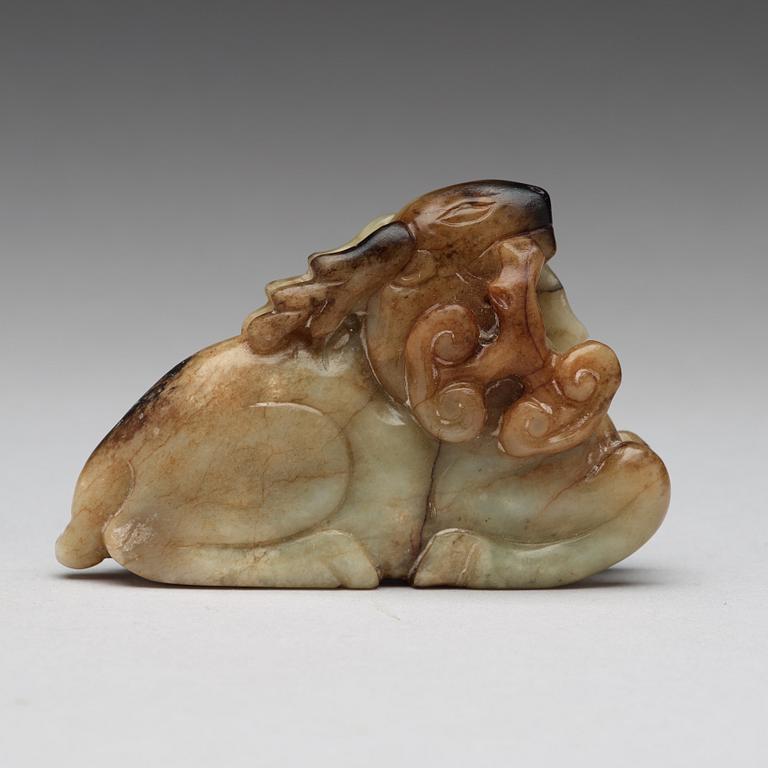 A carved nephrite figure of a reclining deer, late Qing dynasty.