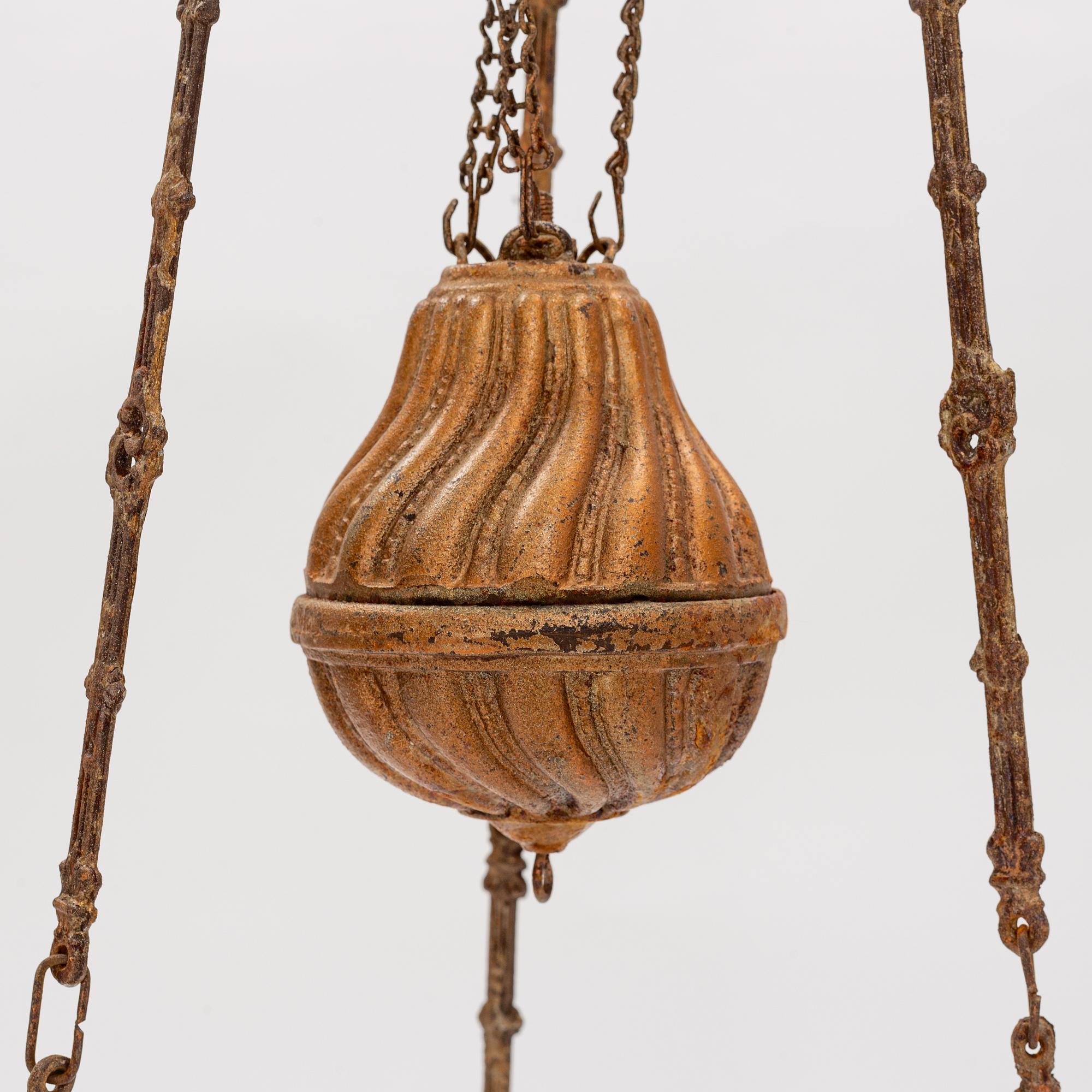 A ceiling carosene lamp, circa 1900.