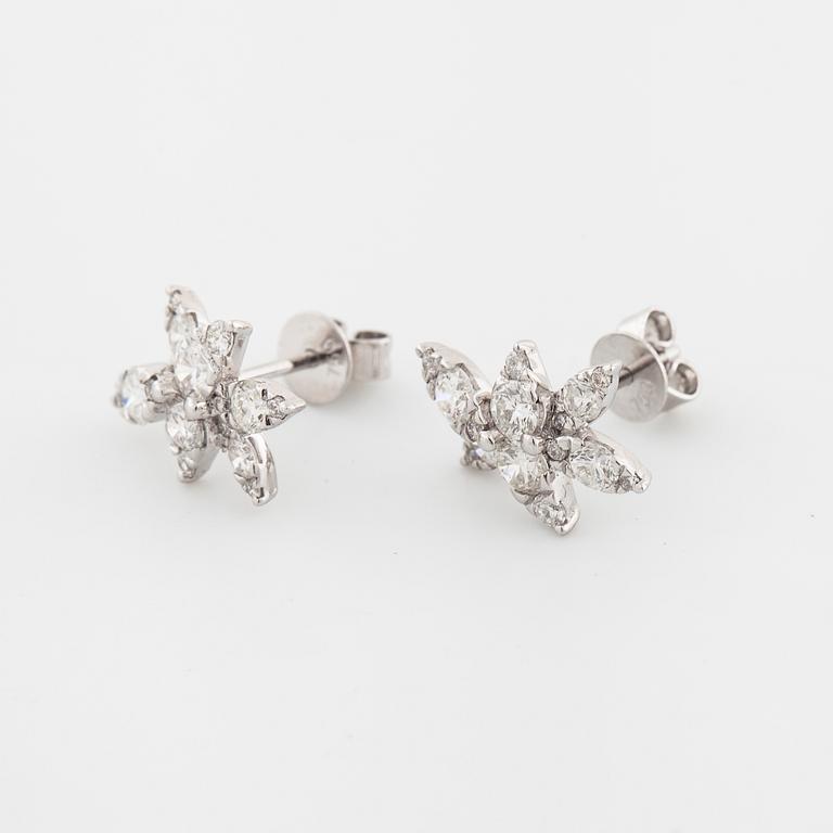 A pair of brilliant cut diamond earrings.