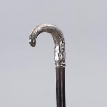 A CANE WITH SILVER MOUNTING, 1910.