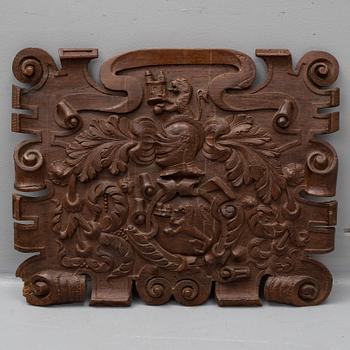 An 18th century carved oak crest.