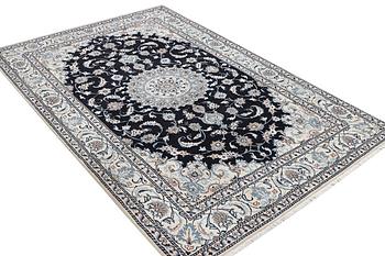 A Nain carpet, part silk, c. 286 x 206 cm.