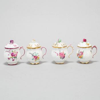 A set of four odd soft paste custard cups with covers, 18th Century.