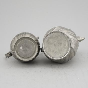 A pair of rococo style pewter coffee pots, from around year 1900.