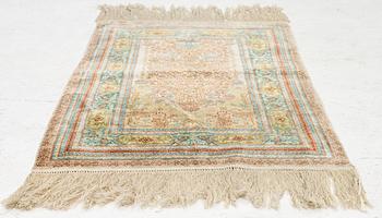 A semi-antique silk Hereke, c. 92 x 61 cm.
