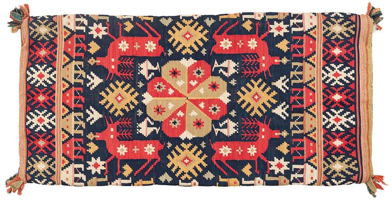 A double-interlocked tapestry carrige cushion from Scania, ca 99 x 49 cm, first half of the 19th century.