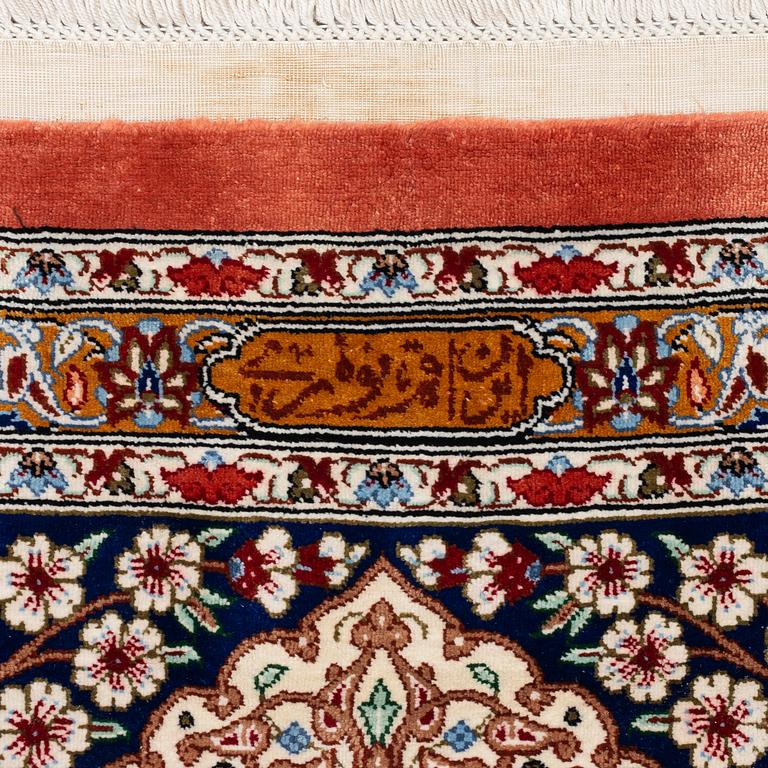 An Oktagonal  silk Qum rug, Central Persia, signed, c. 250 x 250 cm.
