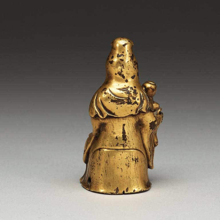 A seated gilt bronze figure of Guanyin with a small boy, Qing dynasty, 18th Century.