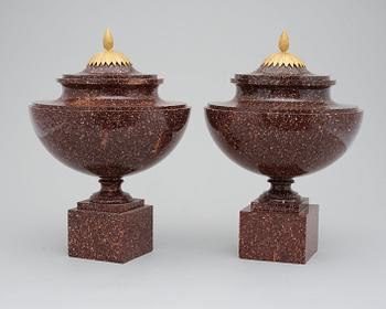 A pair of late Gustavian early 19th century porphyry urns with covers.