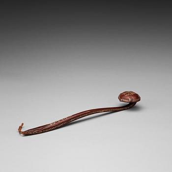 106. A lacquer and mother-of-peal ruyi sceptre, Qing dynasty with an inscription.