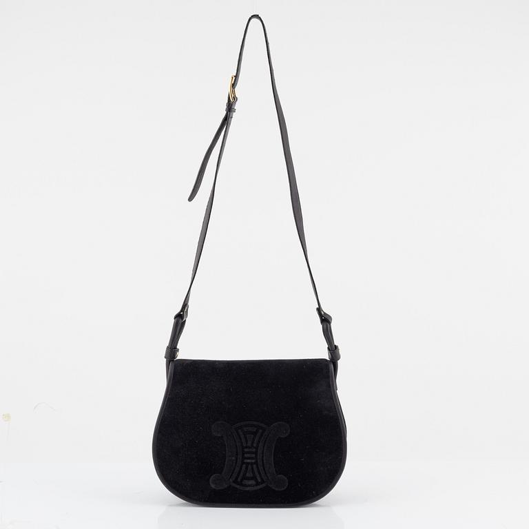 Céline, a black suede handbag.