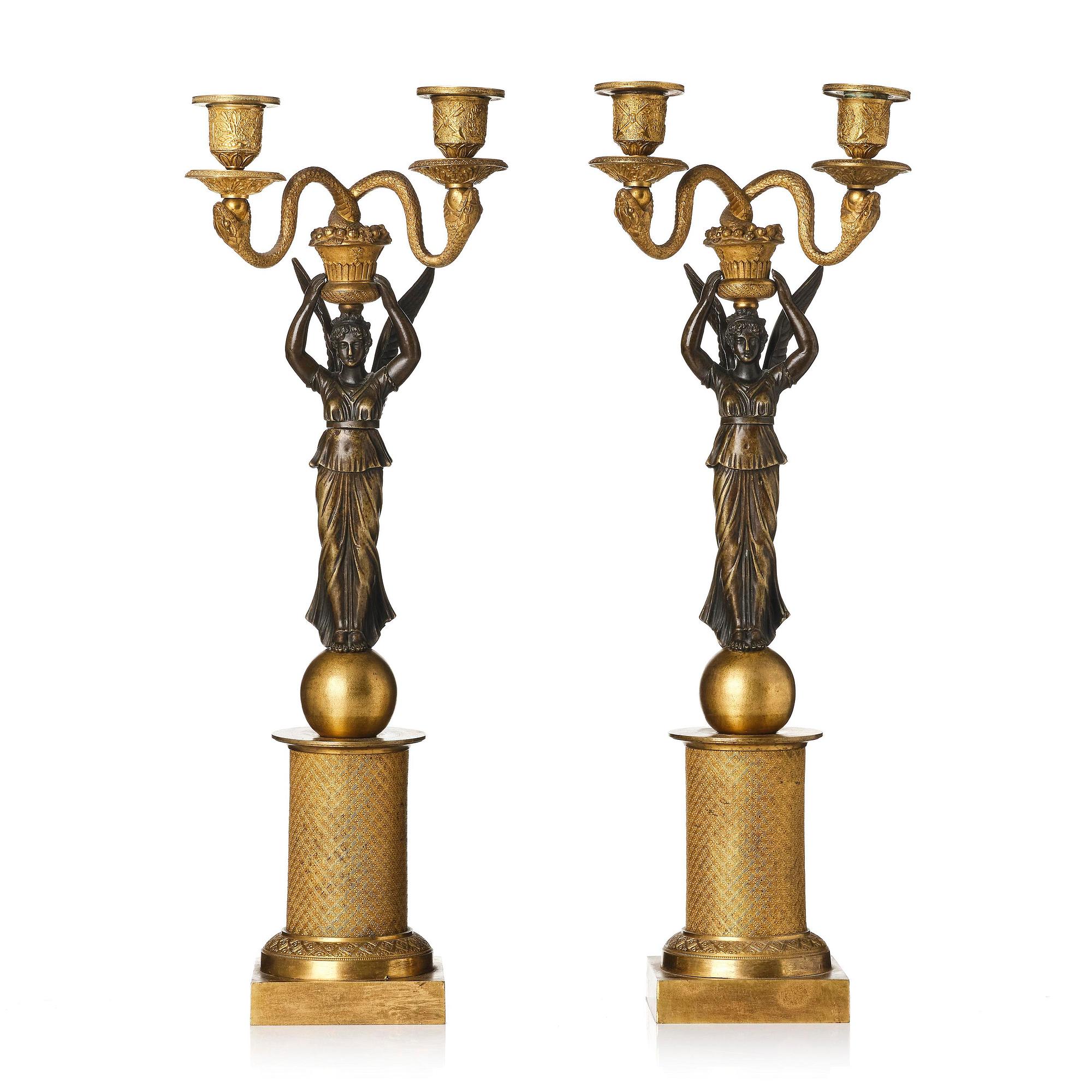 A pair of gilt and patinated bronze Empire-style two branch candelabra, later part 18th century.